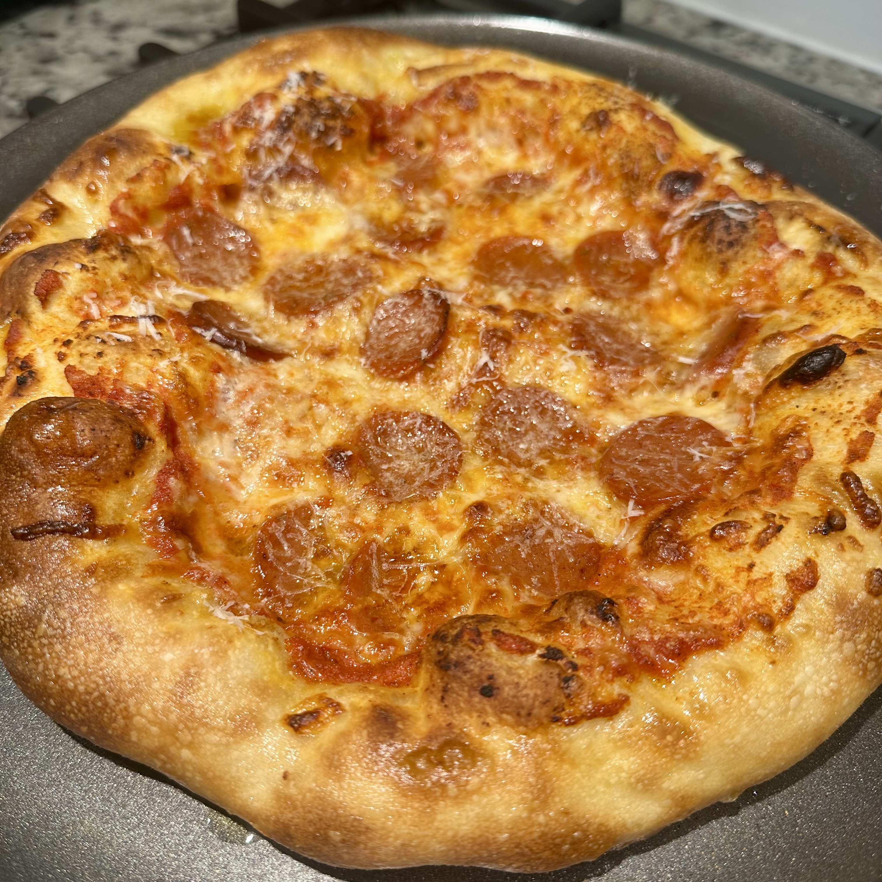 Homemade pepperoni pizza asking for daddy to slice it